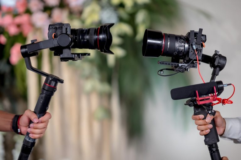 Photographer's hand holding a wedding video camera